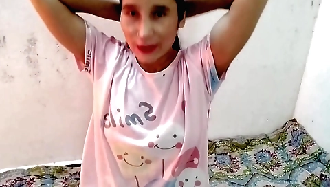 A sexy brunette shows her natural boobs in the room