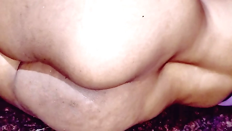 Indian girl in red leather shorts is getting a massage