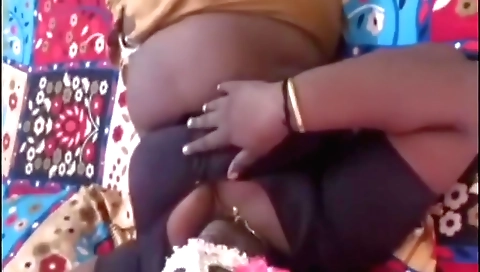 Indian mature woman hunking in her bed from behind